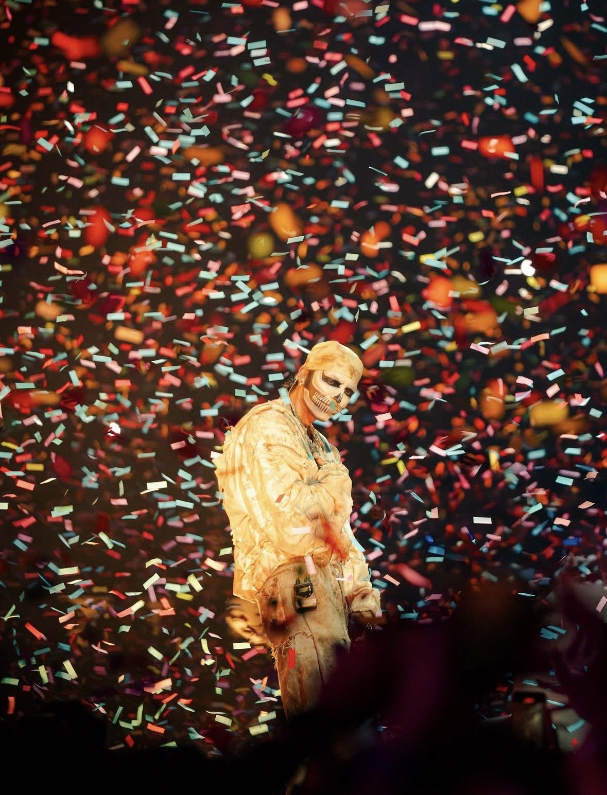 Performer in gold under falling confetti