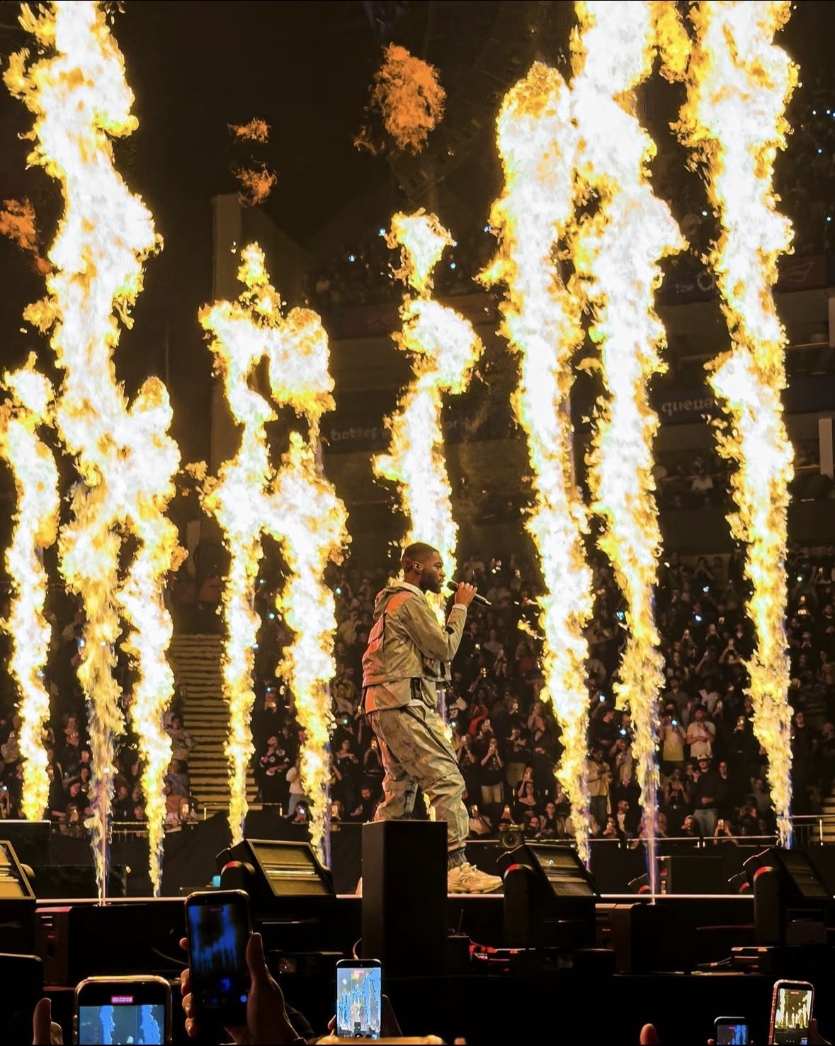 Performer between columns of stage pyrotechnics