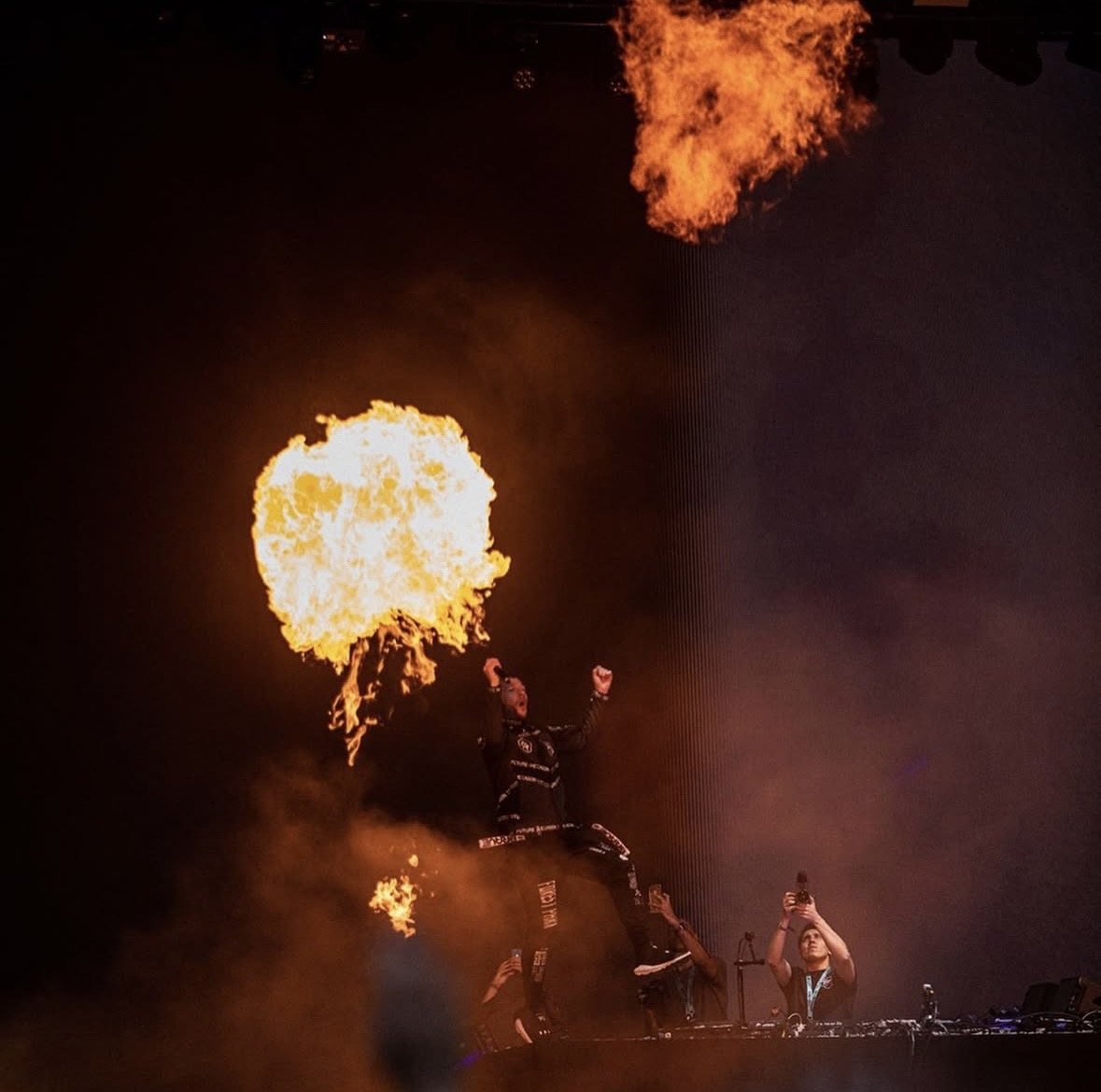 Fireball erupting behind a performer on stage