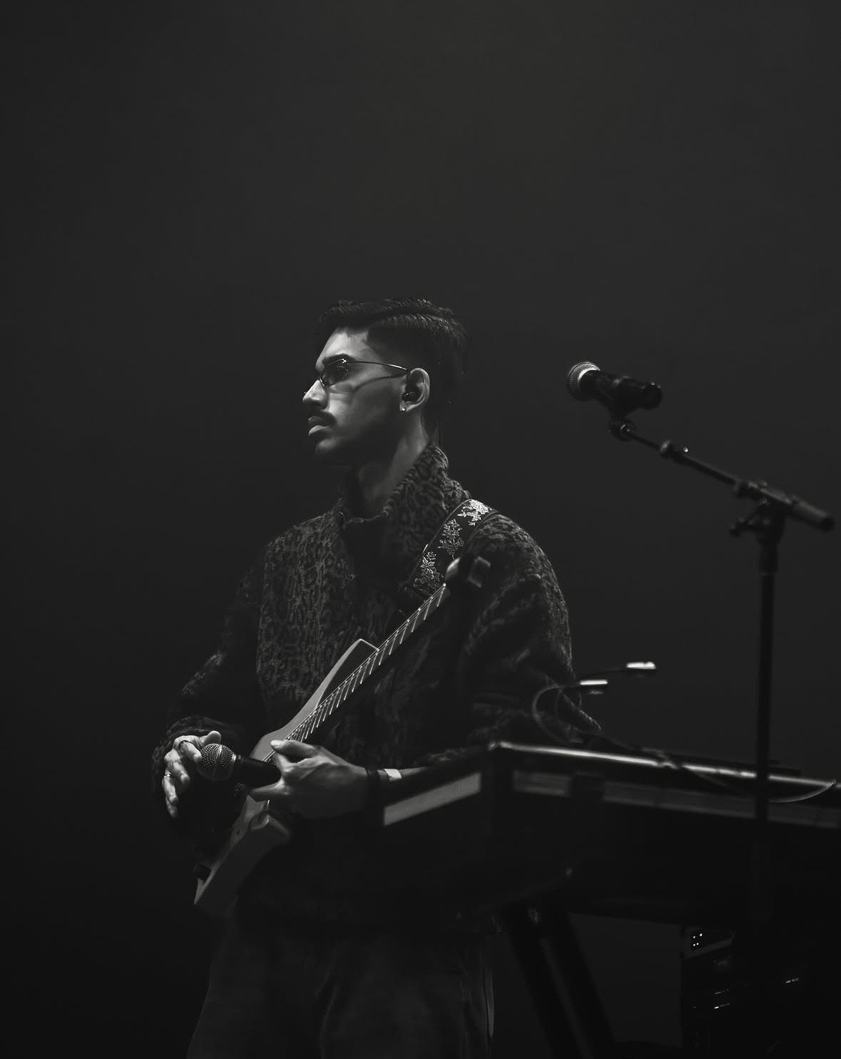 Black and white frame of a musician at a keyboard