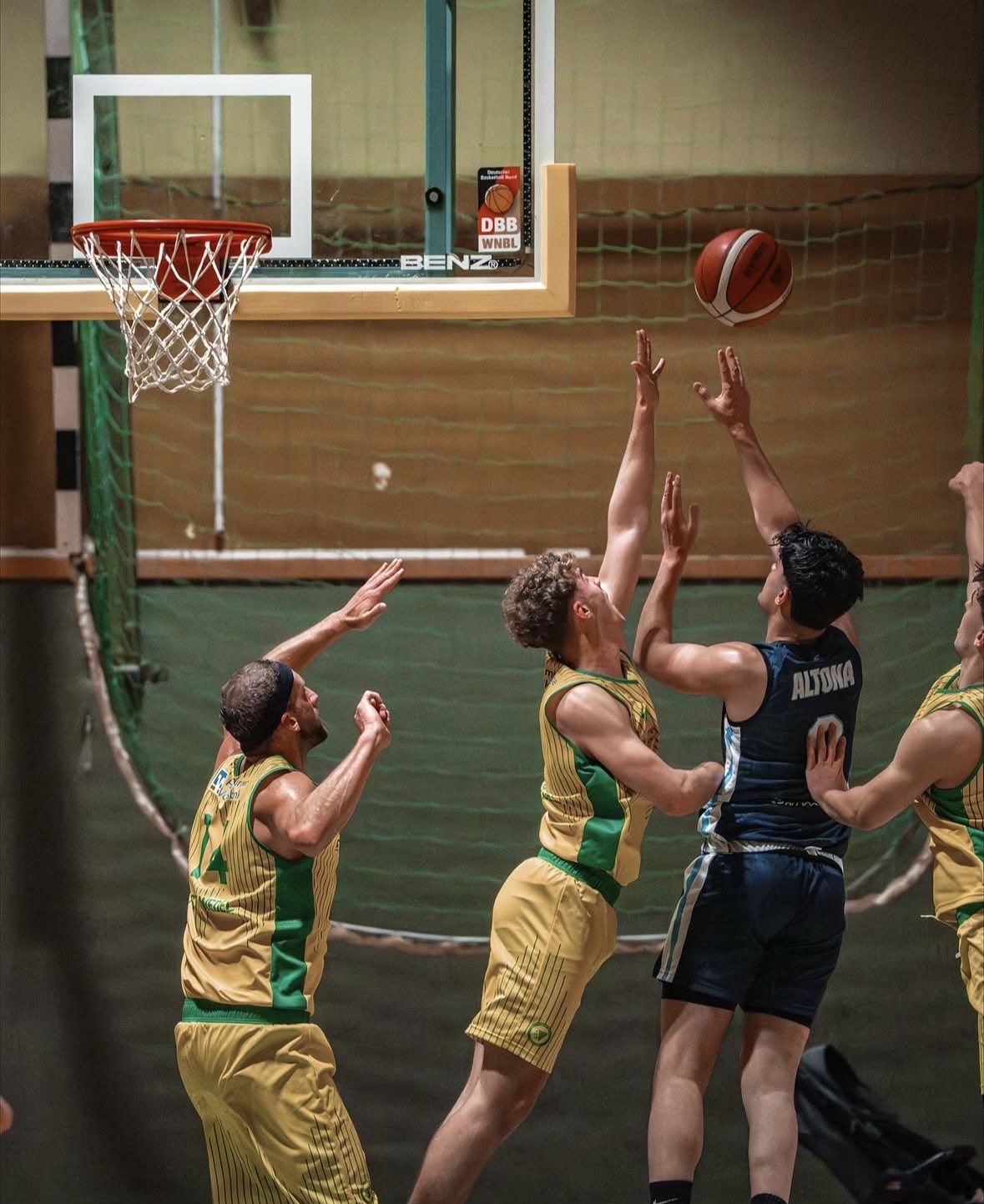 Players competing for a rebound under the basket